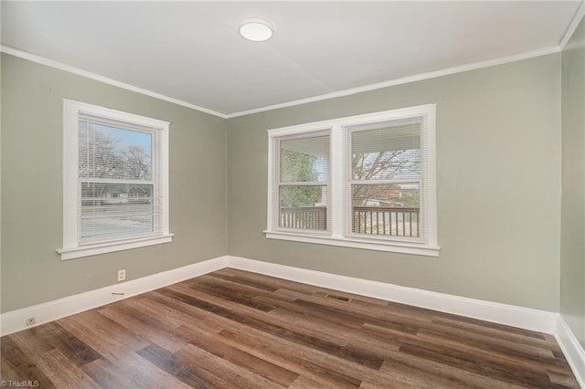 spare room with ornamental molding and dark wood-type flooring