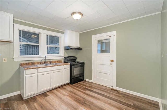 kitchen with crown molding, sink, white cabinets, light hardwood / wood-style floors, and black electric range oven