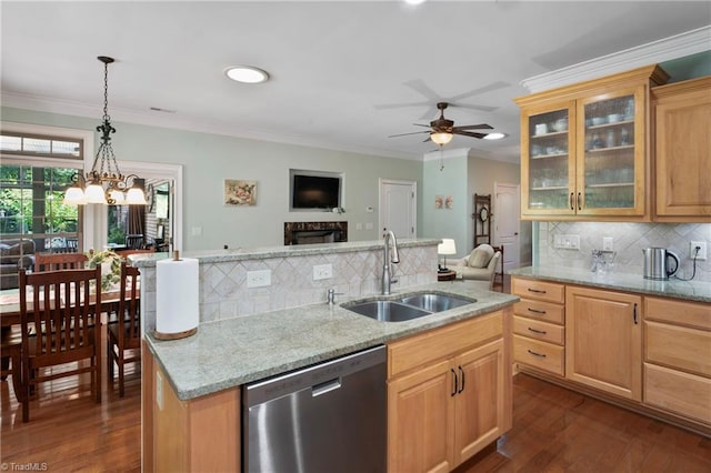 kitchen featuring ceiling fan with notable chandelier, dark hardwood / wood-style flooring, stainless steel dishwasher, sink, and decorative backsplash