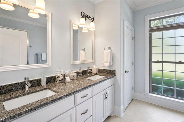 bathroom with crown molding, vanity, and tile patterned flooring