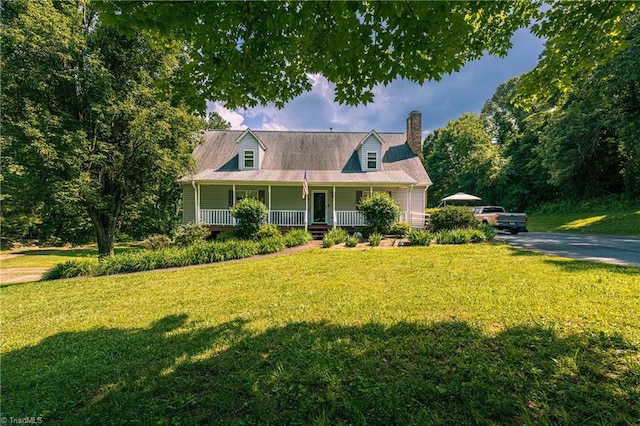 5750 Gayray St, Clemmons, NC 27012 - view of front facade featuring covered porch, a chimney, and a front lawn