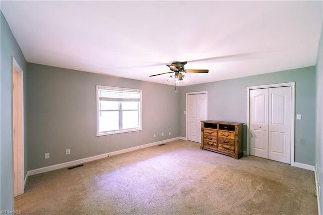 5750 Gayray St, Clemmons, NC 27012 - unfurnished bedroom with carpet, multiple closets, and ceiling fan