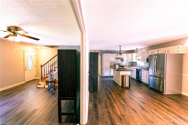 5750 Gayray St, Clemmons, NC 27012 - kitchen featuring stainless steel appliances, dark wood-type flooring, a textured ceiling, ceiling fan, and white cabinets
