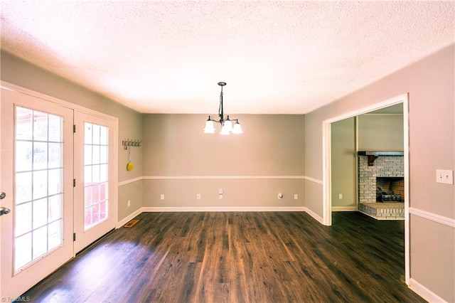 5750 Gayray St, Clemmons, NC 27012 - unfurnished room with dark wood finished floors, a chandelier, a fireplace, and a textured ceiling