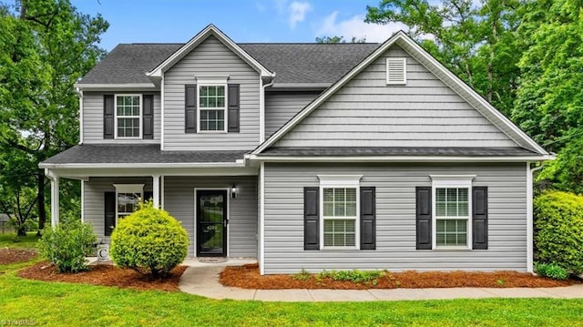 4202 Lake Jeanette Rd, Greensboro, NC 27455 - view of front facade with a porch, a front yard, and roof with shingles
