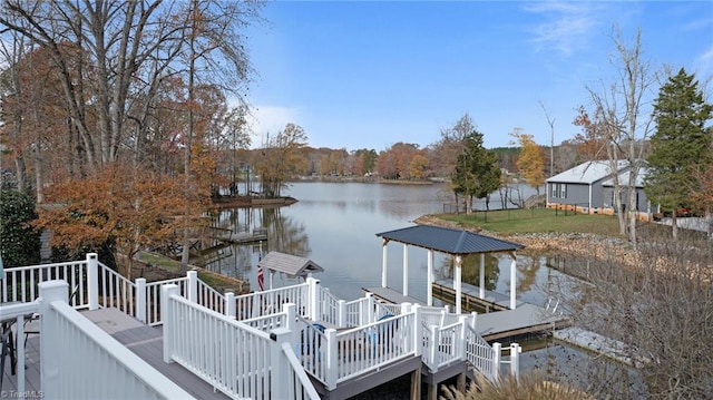 view of dock featuring a deck with water view and a yard