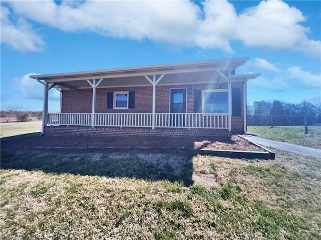 view of front of house featuring brick siding and covered porch