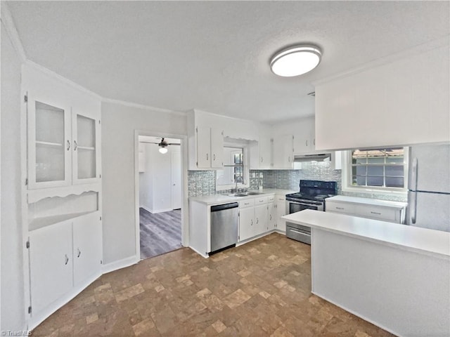 kitchen with under cabinet range hood, white cabinets, stainless steel appliances, and light countertops