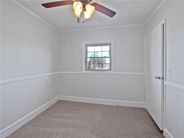 unfurnished room featuring carpet, ceiling fan, and crown molding