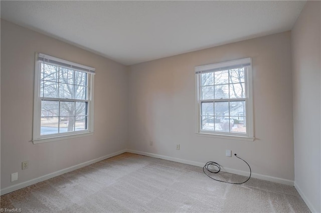 unfurnished room with light carpet