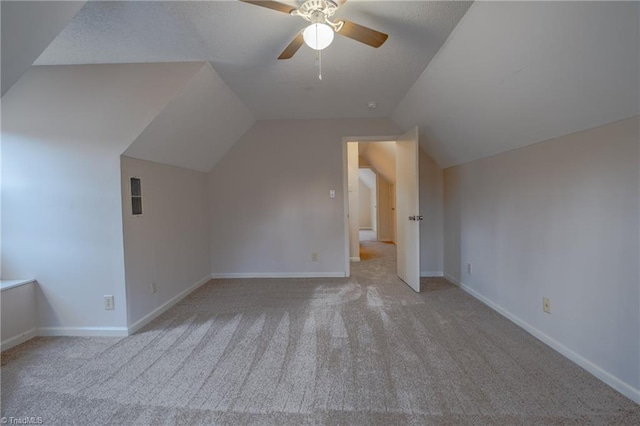 bonus room featuring lofted ceiling, light colored carpet, and ceiling fan