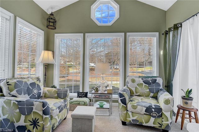 living area featuring carpet, vaulted ceiling, and plenty of natural light