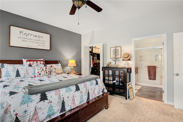 bedroom featuring connected bathroom, ceiling fan, and light colored carpet