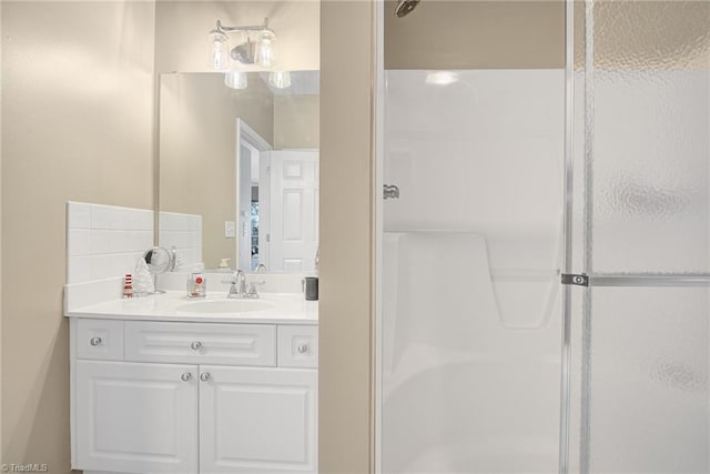 bathroom featuring vanity and an enclosed shower