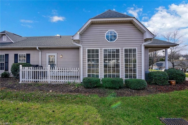 rear view of house with a yard