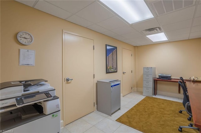 tiled office space featuring a drop ceiling