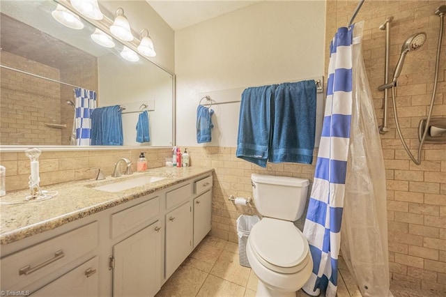 2205 Sedgemont Dr, Winston-Salem, NC 27103 - bathroom featuring vanity, tiled shower, tile patterned floors, tile walls, and wainscoting