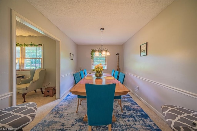 2205 Sedgemont Dr, Winston-Salem, NC 27103 - dining room with carpet, a chandelier, and a textured ceiling