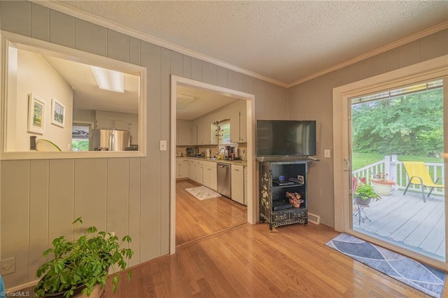2205 Sedgemont Dr, Winston-Salem, NC 27103 - entryway featuring light wood-style floors, healthy amount of natural light, ornamental molding, and a textured ceiling
