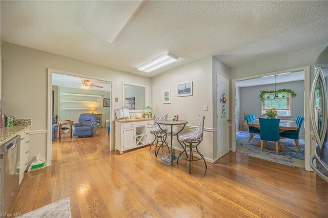 2205 Sedgemont Dr, Winston-Salem, NC 27103 - kitchen featuring light wood finished floors, a textured ceiling, appliances with stainless steel finishes, white cabinetry, and light countertops