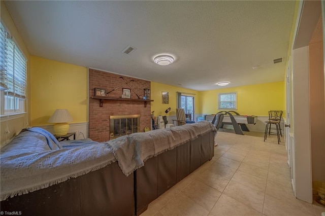 2205 Sedgemont Dr, Winston-Salem, NC 27103 - living area featuring light tile patterned floors, a brick fireplace, and a textured ceiling