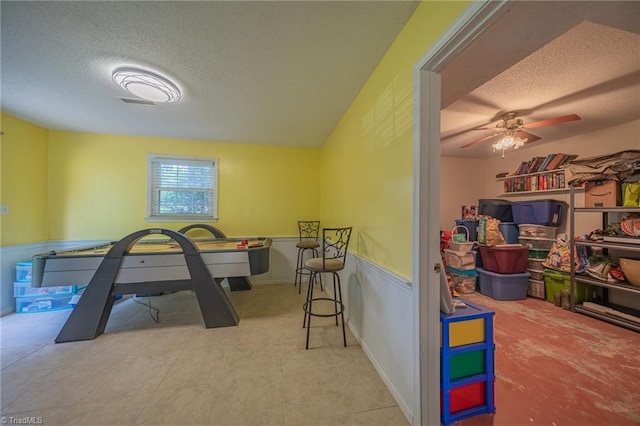 2205 Sedgemont Dr, Winston-Salem, NC 27103 - rec room featuring a textured ceiling, a wainscoted wall, and ceiling fan