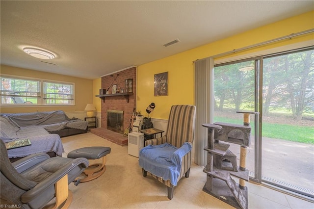 2205 Sedgemont Dr, Winston-Salem, NC 27103 - tiled living room with a fireplace and a textured ceiling