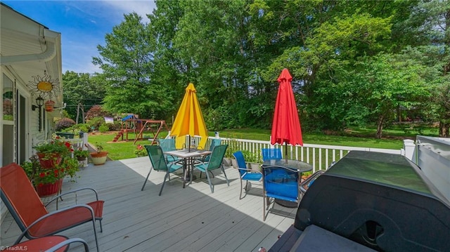 2205 Sedgemont Dr, Winston-Salem, NC 27103 - wooden deck featuring outdoor dining area, a yard, a playground, and view of scattered trees