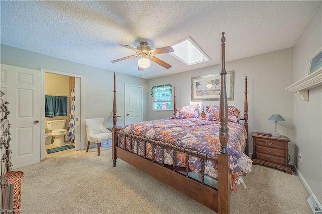 2205 Sedgemont Dr, Winston-Salem, NC 27103 - bedroom featuring a skylight, carpet, connected bathroom, ceiling fan, and a textured ceiling