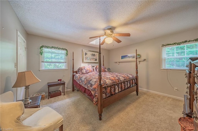 2205 Sedgemont Dr, Winston-Salem, NC 27103 - bedroom featuring multiple windows, a textured ceiling, light colored carpet, and ceiling fan