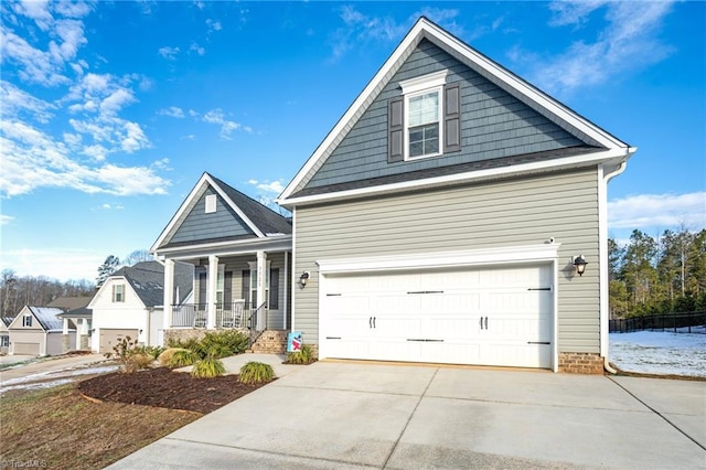 view of front of property featuring a porch and a garage