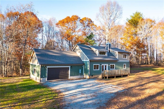 cape cod home with a garage and a front lawn