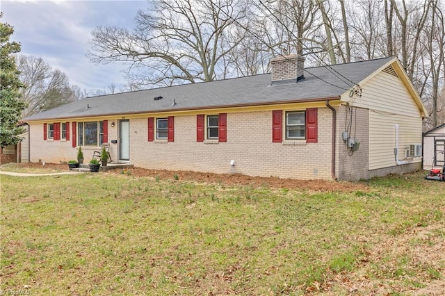 single story home with brick siding, a chimney, and a front lawn