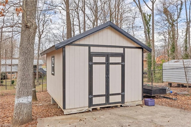 view of shed featuring fence