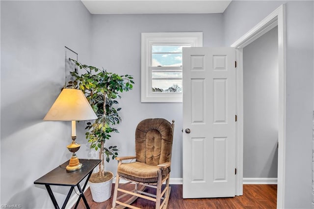 living area featuring wood finished floors and baseboards