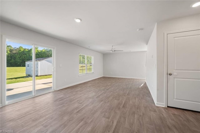 empty room with recessed lighting, baseboards, a ceiling fan, and wood finished floors