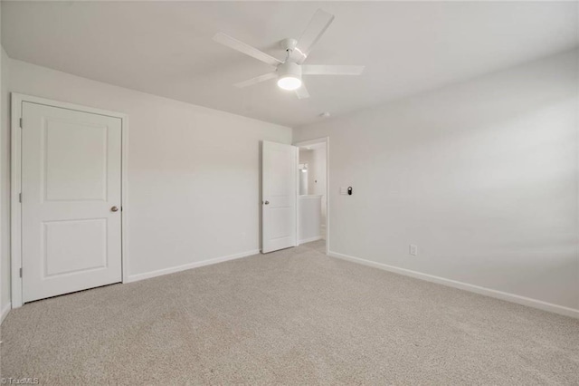 unfurnished bedroom with baseboards, a ceiling fan, and light colored carpet