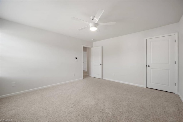 unfurnished bedroom with light carpet, baseboards, and ceiling fan