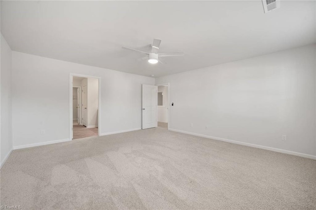 unfurnished bedroom with ensuite bath, visible vents, ceiling fan, light carpet, and baseboards