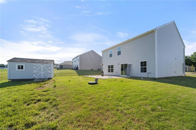 rear view of house featuring a yard, a shed, an outdoor structure, and a patio