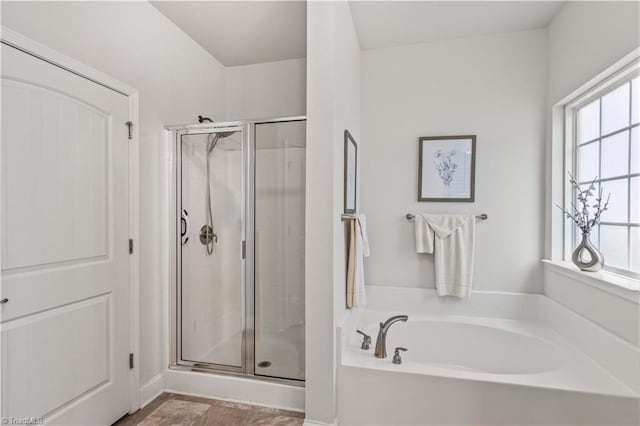 bathroom featuring plus walk in shower