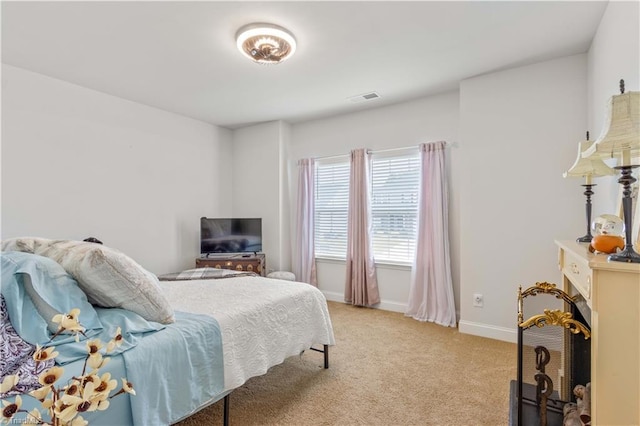 bedroom featuring light colored carpet