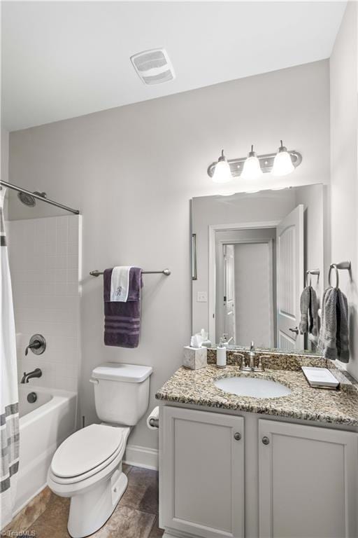 full bathroom featuring shower / bath combo, vanity, and toilet