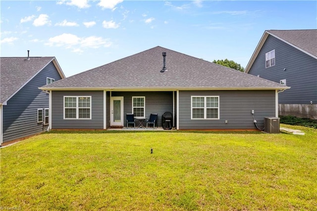 back of house with a yard and central AC unit