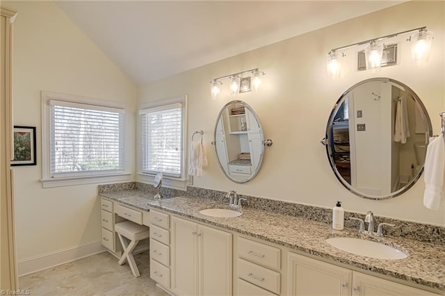 full bathroom with lofted ceiling, a sink, baseboards, and double vanity