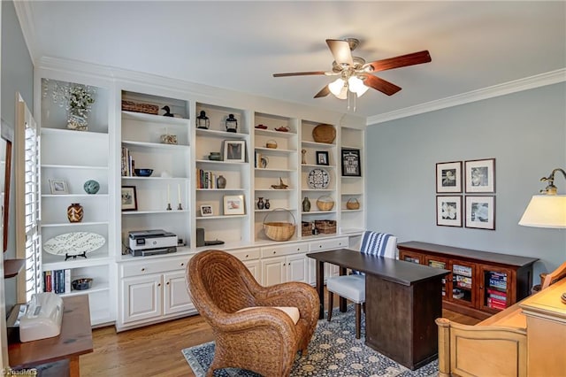 office area featuring light wood finished floors, ornamental molding, and a ceiling fan