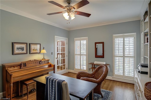 office space featuring ceiling fan, ornamental molding, wood finished floors, and baseboards