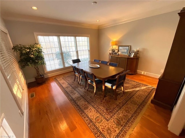 dining area featuring crown molding and hardwood / wood-style floors