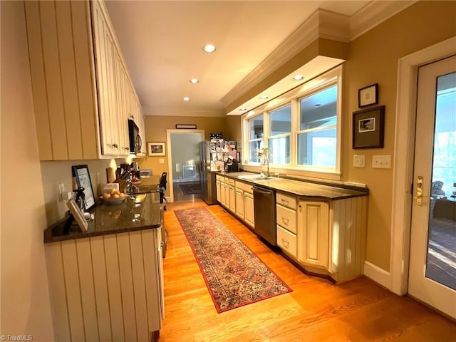 kitchen with black appliances, crown molding, sink, dark stone countertops, and light wood-type flooring