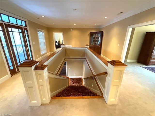 stairs with carpet floors and crown molding